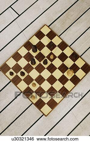 High angle view of chess pieces on a chessboard View Large Photo Image Stock Photograph - High angle view of chess pieces on a chessboard. Fotosearch