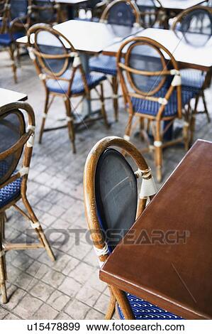 Stock Photo - High angle view of empty chairs and tables in a restaurant. Fotosearch