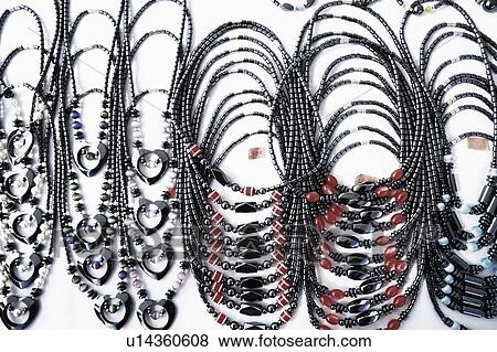 Stock Photo - High angle view of necklaces at a market stall. Fotosearch