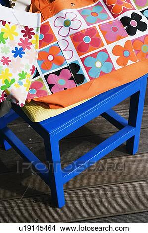 High angle view of shopping bags on a stool View Large Photo Image Picture - High angle view of shopping bags on a stool. Fotosearch