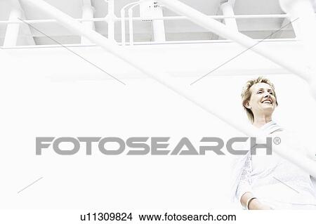 Low angle view of a mature woman smiling View Large Photo Image Picture - Low angle view of a mature woman smiling. Fotosearch