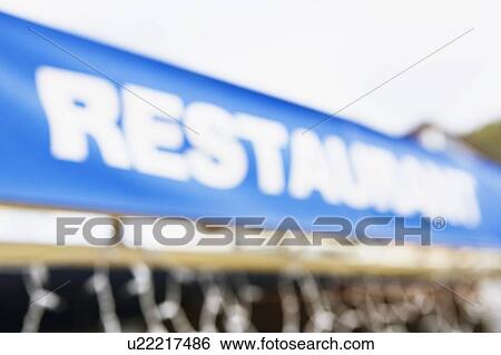 Stock Photograph - Low angle view of a restaurant signboard. Fotosearch