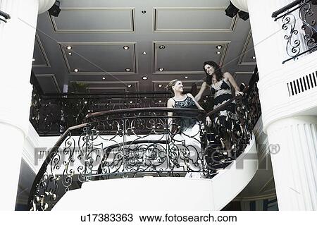 Low angle view of two mid adult women standing at the balcony of a ship View Large Photo Image Stock Image - Low angle view of two mid adult women standing at the balcony of a ship. Fotosearch