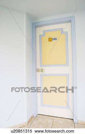Stock Photography - Number on a closed door of a hotel room. Fotosearch
