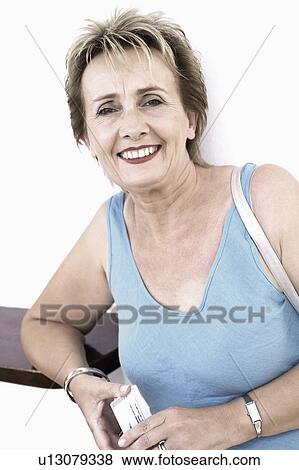 Portrait of a mature woman smiling View Large Photo Image Stock Photo - Portrait of a mature woman smiling. Fotosearch