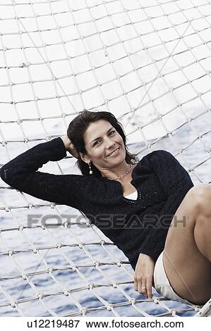 Portrait of a mid adult woman lying in a hammock View Large Photo Image Stock Photo - Portrait of a mid adult woman lying in a hammock. Fotosearch