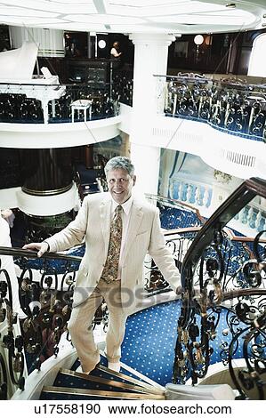 Portrait of a senior man moving up on a staircase of a ship View Large Photo Image Stock Image - Portrait of a senior man moving up on a staircase of a ship. Fotosearch