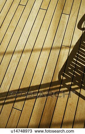 Shadow of a lounge chair on a floorboard View Large Photo Image Stock Image - Shadow of a lounge chair on a floorboard. Fotosearch