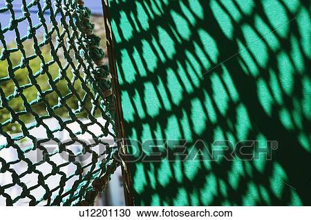 Stock Image - Shadow of a net on the wall. Fotosearch