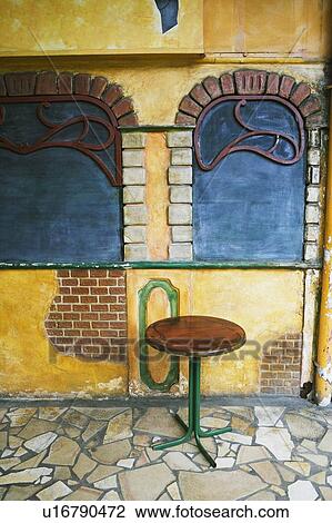 Stock Image - Stool in front of a wall of a building. Fotosearch