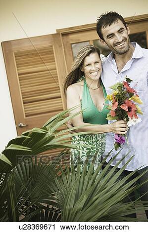 Young man and a mid adult woman standing together View Large Photo Image Stock Image - Young man and a mid adult woman standing together. Fotosearch