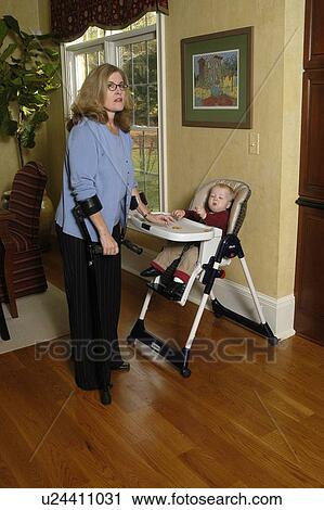 Stock Image - A grandmother gives her grandson a morning snack.. Fotosearch