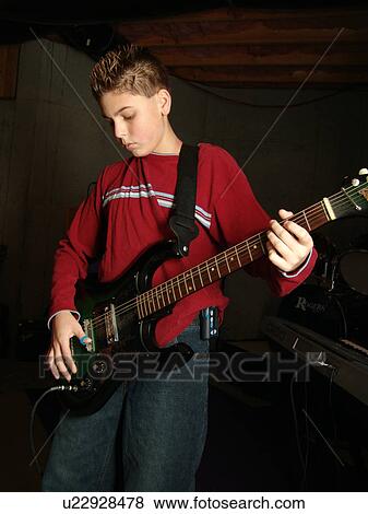 A young boy with diabetics enjoys playing on his guitar. View Large Photo Image Stock Photo - A young boy with diabetics enjoys playing on his guitar.. Fotosearch