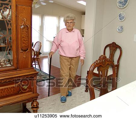 An elderly woman enters her dinning room from the kitchen. An elderly woman enters her dining room from the kitchen. View Large Photo Image Stock Photography - An elderly woman enters her dinning room from the kitchen. An elderly woman enters her dining room from the kitchen.. Fotosearch