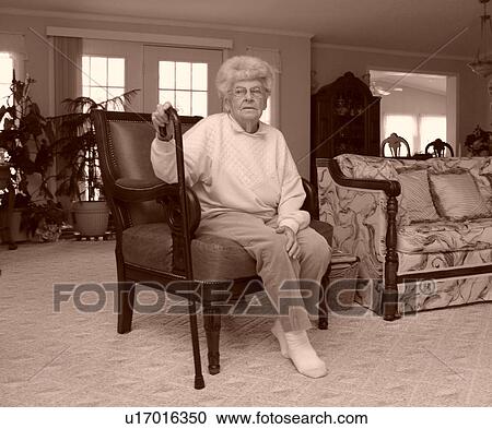 An elderly woman takes a break in her living room. View Large Photo Image Stock Image - An elderly woman takes a break in her living room.. Fotosearch
