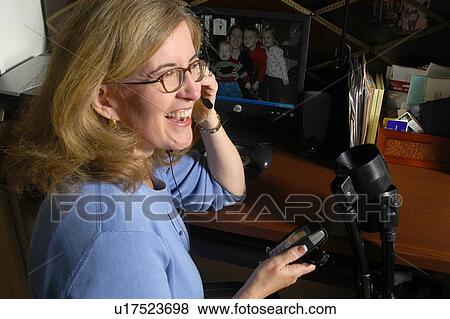 Stock Photo - Attractive female talks on the phone.. Fotosearch