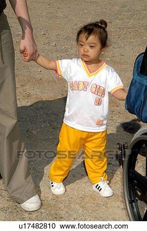 Cute little girl with Downs Syndrome have a great day with her family and friends. View Large Photo Image Stock Image - Cute little girl with Downs Syndrome have a great day with her family and friends.. Fotosearch