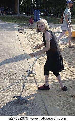Girl with a disability using canes for mobility assistance leaving the playground after having a really good time. View Large Photo Image Stock Photography - Girl with a disability using canes for mobility assistance leaving the playground after having a really good time.. Fotosearch