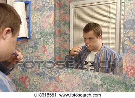 Man with a disability brushing his teeth and preparing for his day. View Large Photo Image Stock Image - Man with a disability brushing his teeth and preparing for his day.. Fotosearch