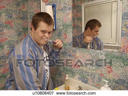 Man with a disability brushing his teeth and preparing for his day. View Large Photo Image Stock Photo - Man with a disability brushing his teeth and preparing for his day.. Fotosearch