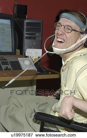 Man with significant disabilities utilizing headgear to operate communications apparatus. View Large Photo Image Stock Photo - Man with significant disabilities utilizing headgear to operate communications apparatus.. Fotosearch