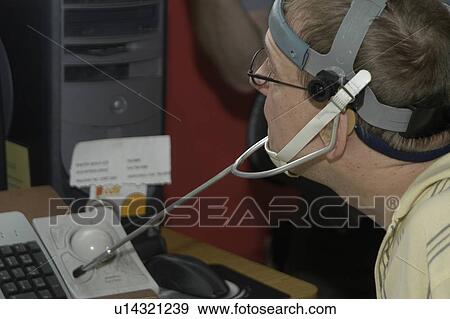 Man with significant disabilities using headgear to operate communications apparatus. View Large Photo Image Stock Photo - Man with significant disabilities using headgear to operate communications apparatus.. Fotosearch