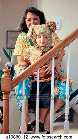 Woman with muscular dystrophy going up the stairs with her costumed child via a chair lift that will allow her to go up and down stairs. View Large Photo Image Stock Image - Woman with muscular dystrophy going up the stairs with her costumed child via a chair lift that will allow her to go up and down stairs.. Fotosearch