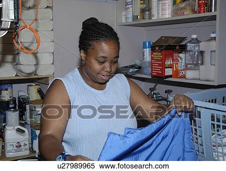 Woman working in a laundry room. View Large Photo Image Stock Photography - Woman working in a laundry room.. Fotosearch