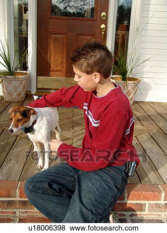 Stock Photo - Young boy enjoys time with his dog.. Fotosearch