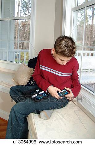 Stock Photograph - Young boy takes an insulin reading.. Fotosearch