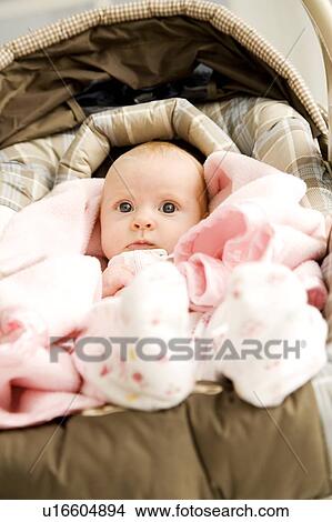 Picture - A baby in a carrier. Fotosearch