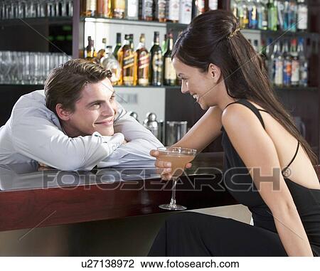 A barman flirting with a customer View Large Photo Image Stock Image - A barman flirting with a customer. Fotosearch