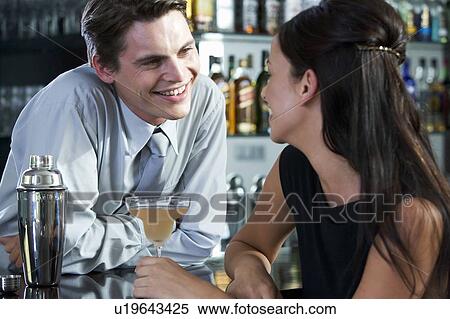 Stock Photography - A barman flirting with a customer. Fotosearch