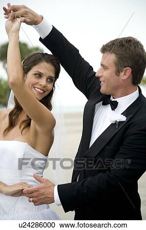 Stock Image - A bride and groom dancing. Fotosearch