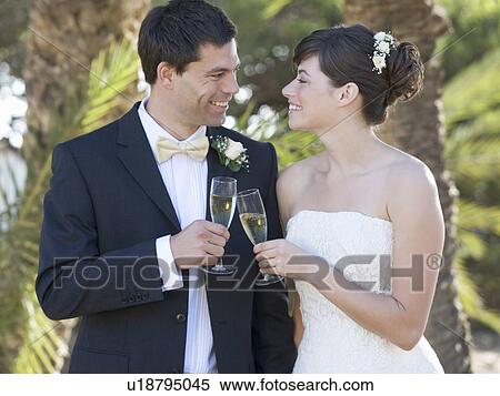 A bride and groom drinking champagne View Large Photo Image Stock Photography - A bride and groom drinking champagne. Fotosearch