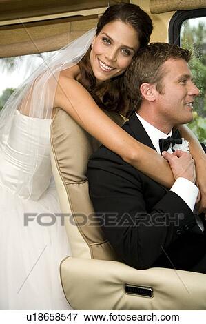 A bride and groom in a car View Large Photo Image Stock Photo - A bride and groom in a car. Fotosearch