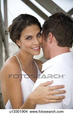 A bride and groom kissing on a beach View Large Photo Image Picture - A bride and groom kissing on a beach. Fotosearch