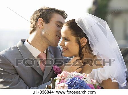 A bride and groom kissing View Large Photo Image Picture - A bride and groom kissing. Fotosearch