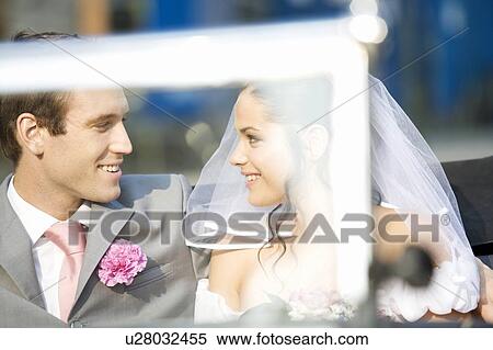 A bride and groom sitting in the wedding car View Large Photo Image Stock Photography - A bride and groom sitting in the wedding car. Fotosearch