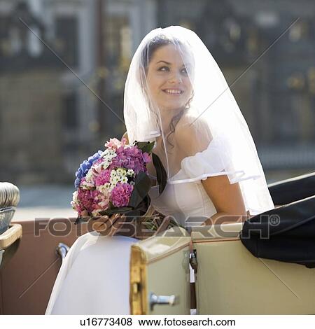 Stock Photo - A bride arriving for her wedding. Fotosearch