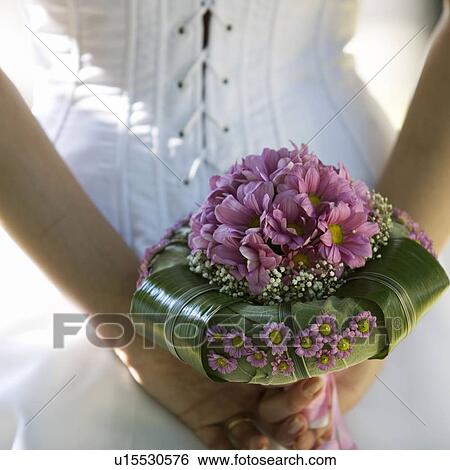 A bride holding a bouquet View Large Photo Image Stock Photograph - A bride holding a bouquet. Fotosearch