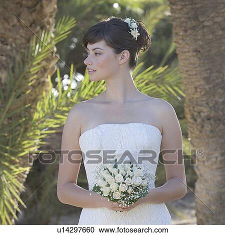 A bride holding her bouquet View Large Photo Image Stock Image - A bride holding her bouquet. Fotosearch