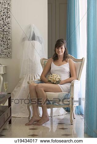 Stock Photo - A bride sitting in a chair. Fotosearch
