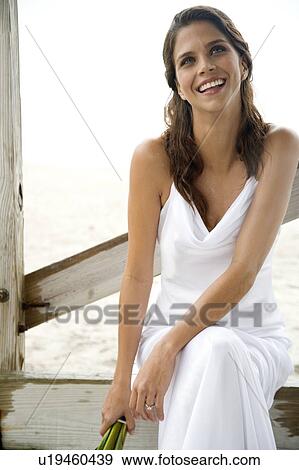 A bride sitting on a beach View Large Photo Image Stock Photo - A bride sitting on a beach. Fotosearch