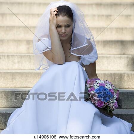 A bride sitting on steps looking sad View Large Photo Image Stock Photograph - A bride sitting on steps looking sad. Fotosearch