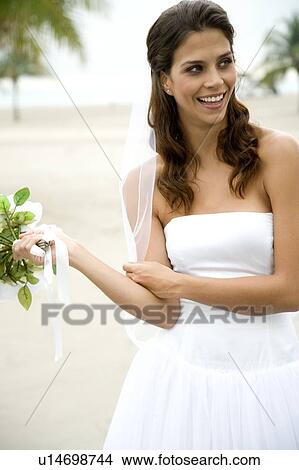A bride standing on a beach View Large Photo Image Picture - A bride standing on a beach. Fotosearch