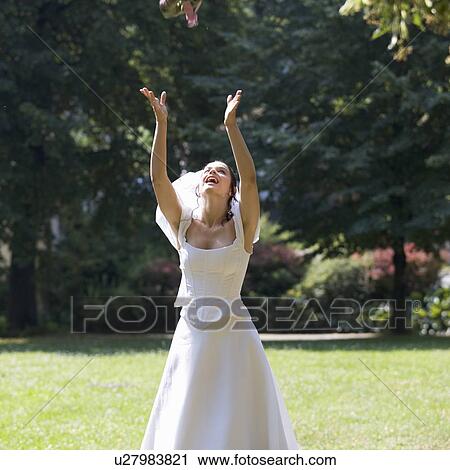 A bride throwing her bouquet View Large Photo Image Stock Image - A bride throwing her bouquet. Fotosearch