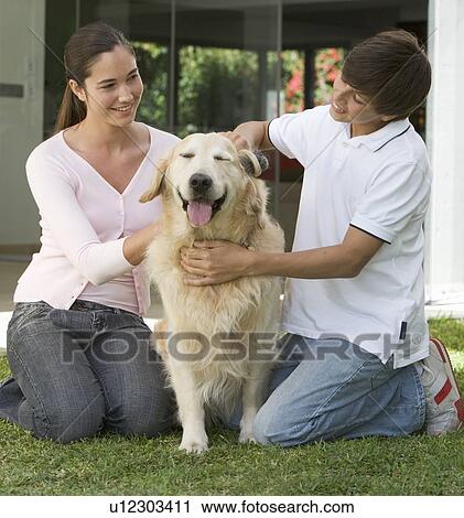 A brother and sister with their dog in the garden View Large Photo Image Stock Image - A brother and sister with their dog in the garden. Fotosearch