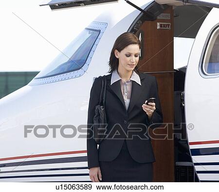 A business woman boarding a plane View Large Photo Image Stock Photo - A business woman boarding a plane. Fotosearch