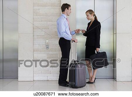 A businessman and woman with suitcases View Large Photo Image Stock Image - A businessman and woman with suitcases. Fotosearch